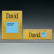 Two David Cinnamon Roll Flavored Bar boxes on a gradient gray background