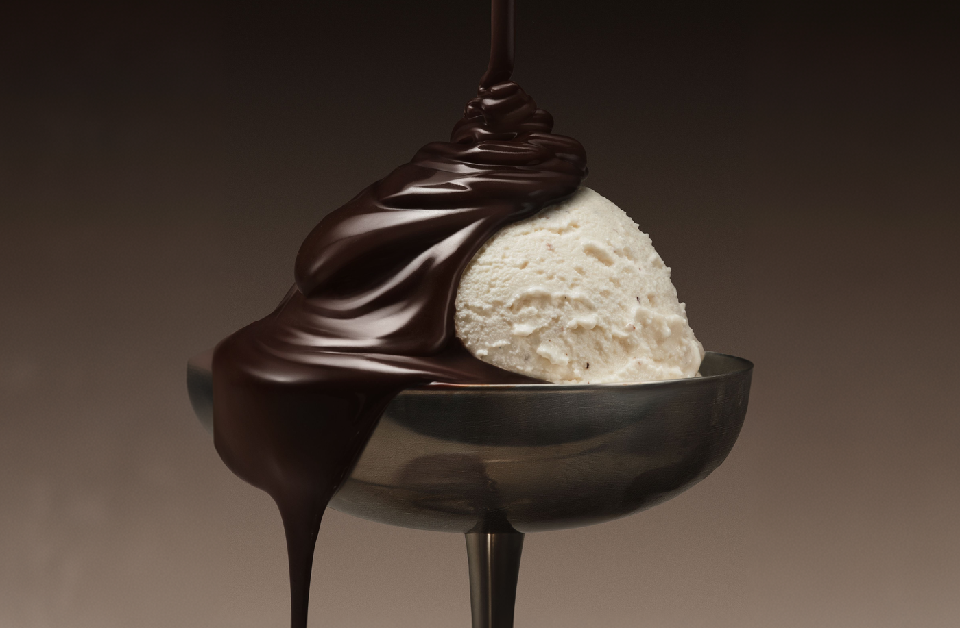 Chocolate drizzling over a scoop of vanilla flavor dessert