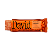 Partially unwrapped David Pumpkin Spice protein bar on a transparent background
