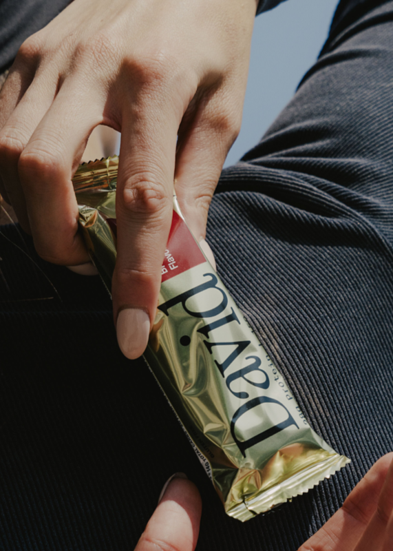 woman holding David protein bar on her back