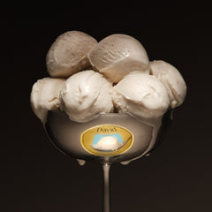 Spoon with six scoops of frozen dessert on a black background