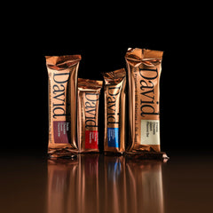 4 David Bronze bars in various flavors standing up against a dark background