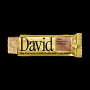 David protein bar with gold wrapper on a black background