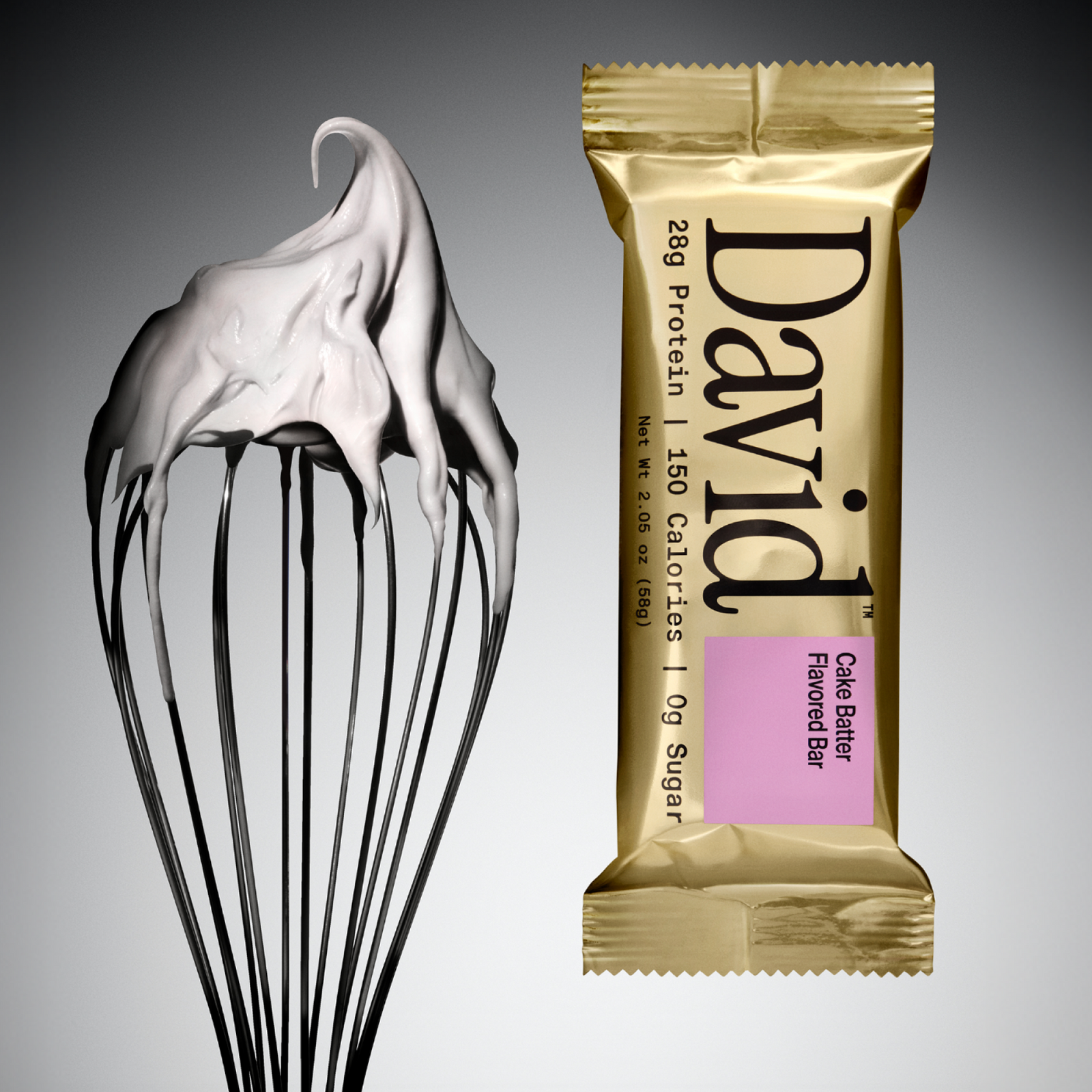 Gold David protein bar with cake batter flavor next to a whisk with batter