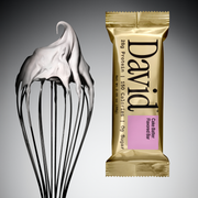 Gold David protein bar with cake batter flavor next to a whisk with batter