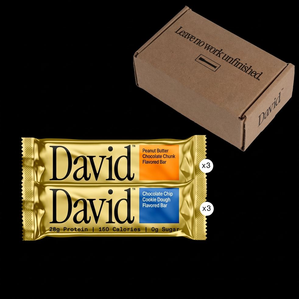 Two David protein bars and a cardboard box on a black background