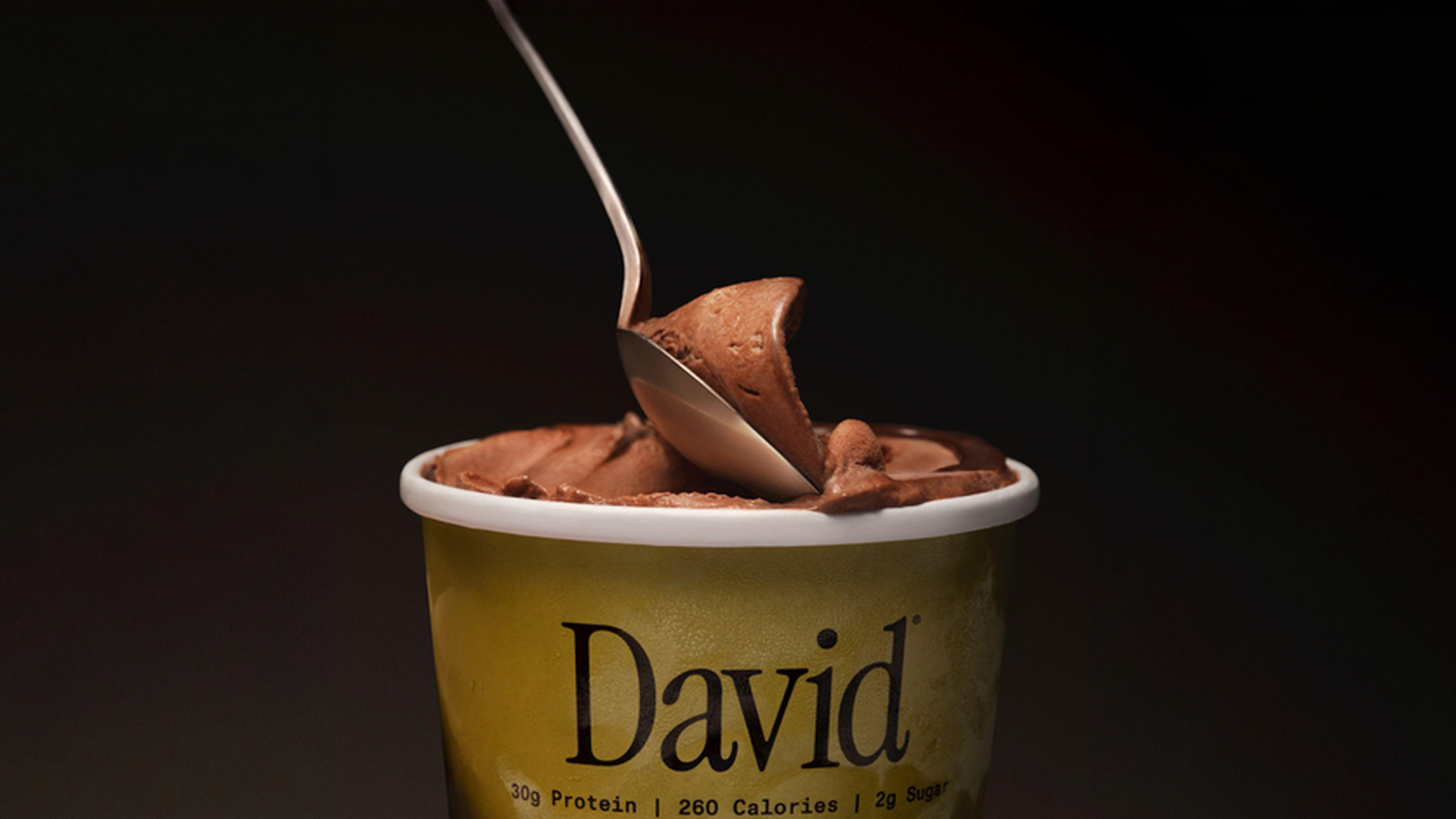 Pint of David frozen dessert with a spoon scooping on the top
