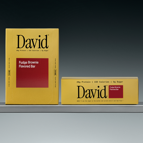 Two David Fudge Brownie Flavored Bar boxes on a shelf with a gray background