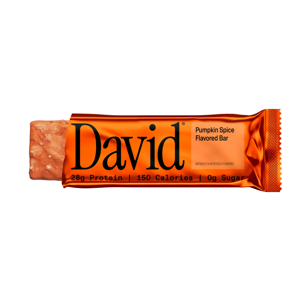 Partially unwrapped David Pumpkin Spice protein bar on a transparent background