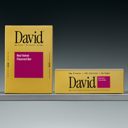 Two David Red Velvet flavored bars on a shelf with a gray background