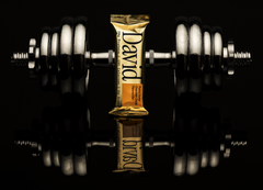David Gold bar with a dumbbell on a reflective black surface
