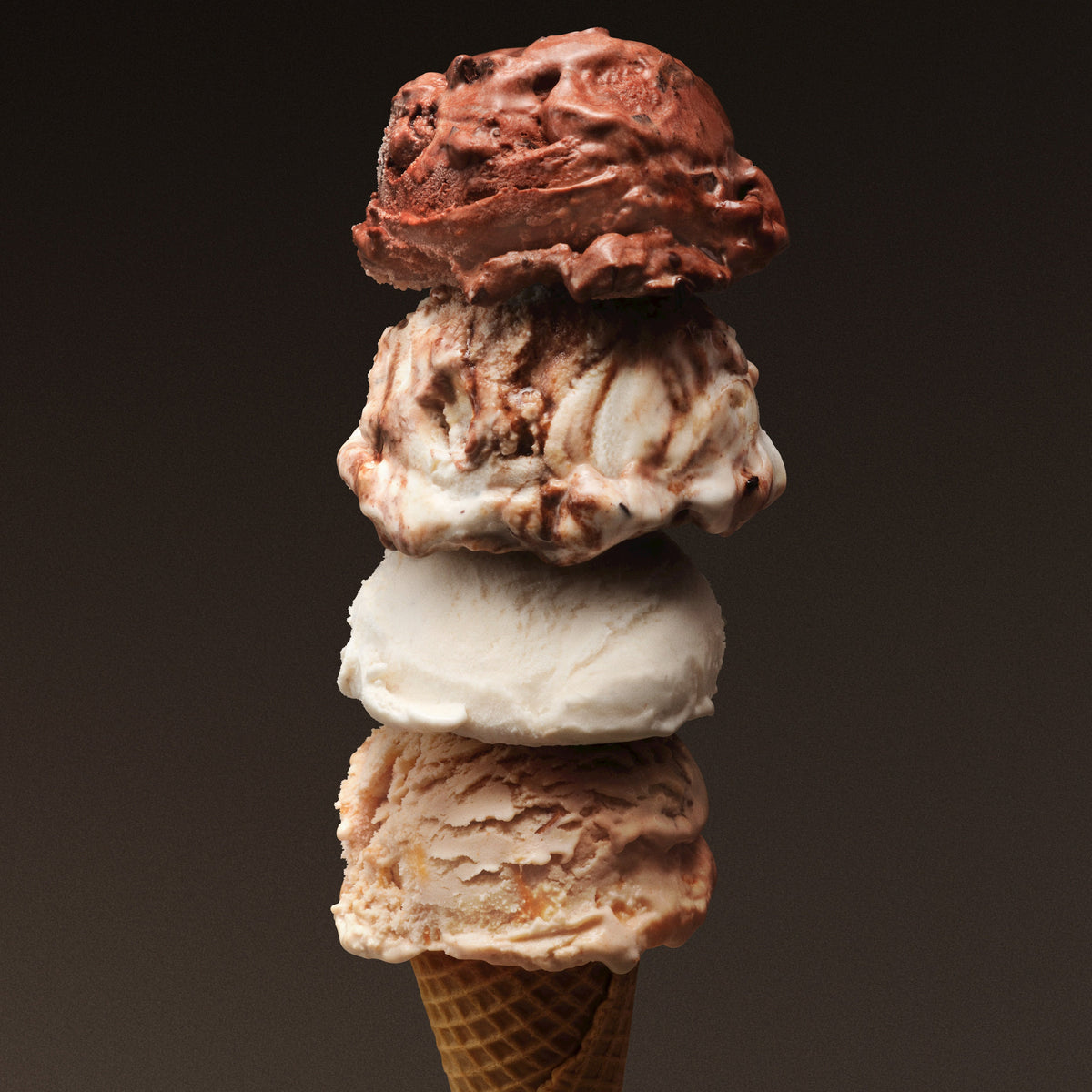 4 scoops of frozen dessert on a cone