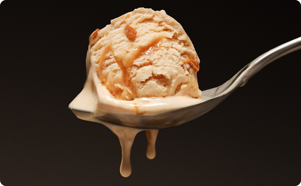 Melting scoop of David Triple Peanut Butter melting on a silver spoon
